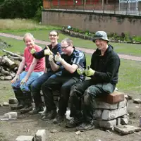 volunteers-celebrating-finishing-a-stone-bench.jpg